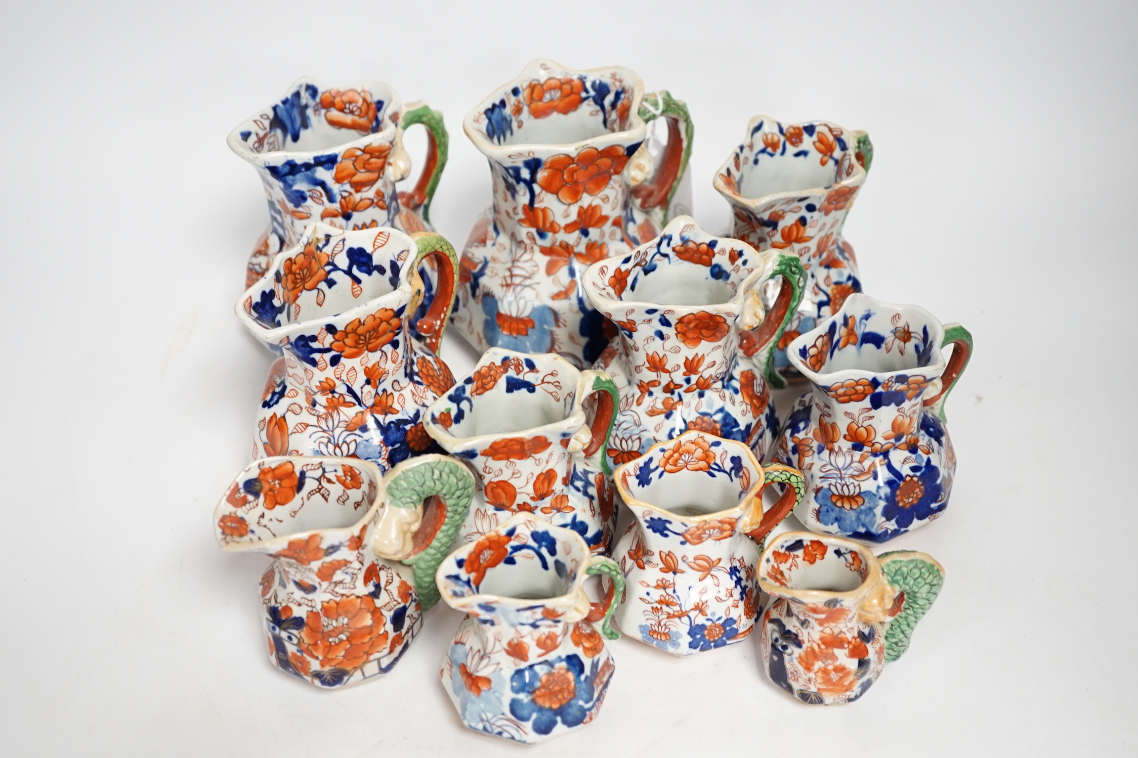 Eleven graduated Masons ironstone jugs, largest 13cm high